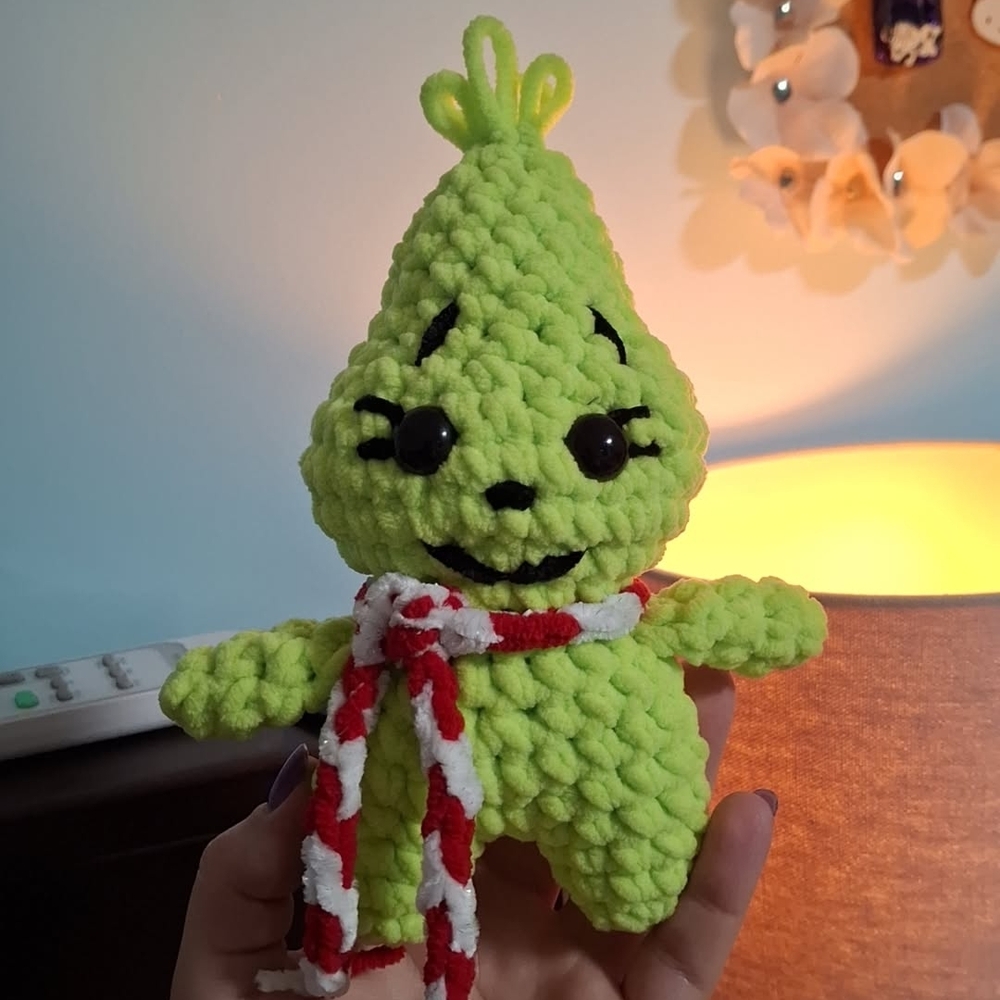 Green Plush Toy with Red and White Scarf